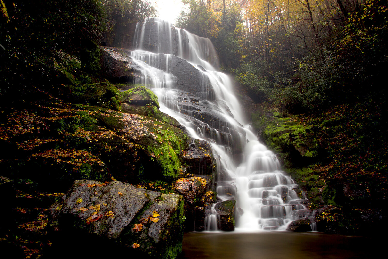 Waterfall cascading through mossy rocks at Eastatoe Falls, North Carolina