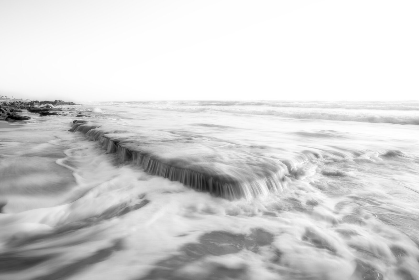Black and white textures of water veins in wet sand