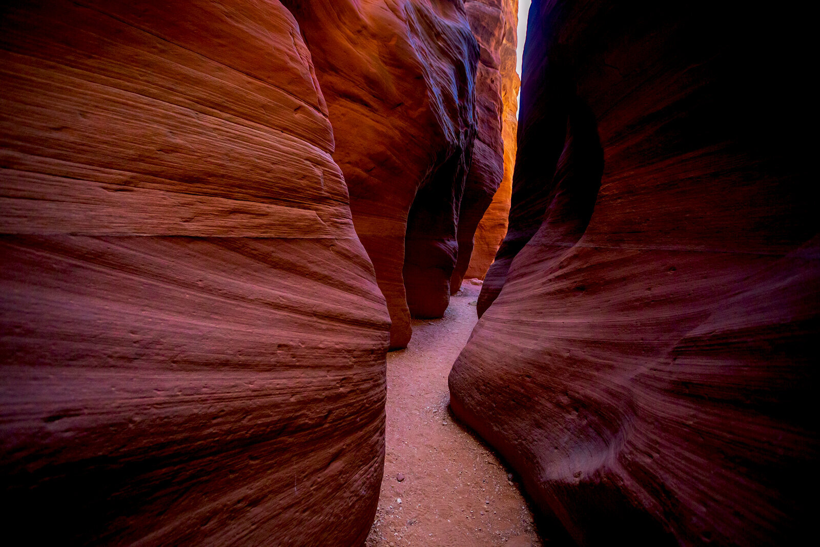 Light beam shining through swirling sandstone walls of Antelope Canyon